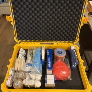 Yellow emergency kit with medical supplies.