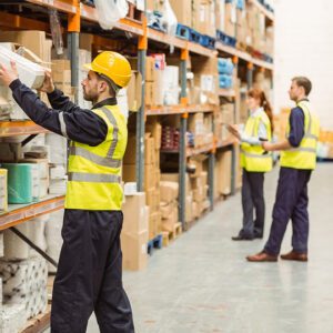 Warehouse workers organizing and checking inventory shelves.