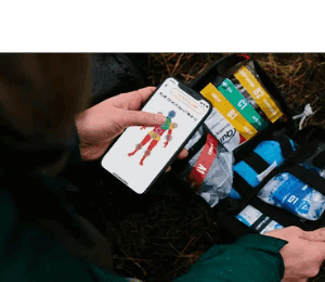 Person using phone app with first aid kit.