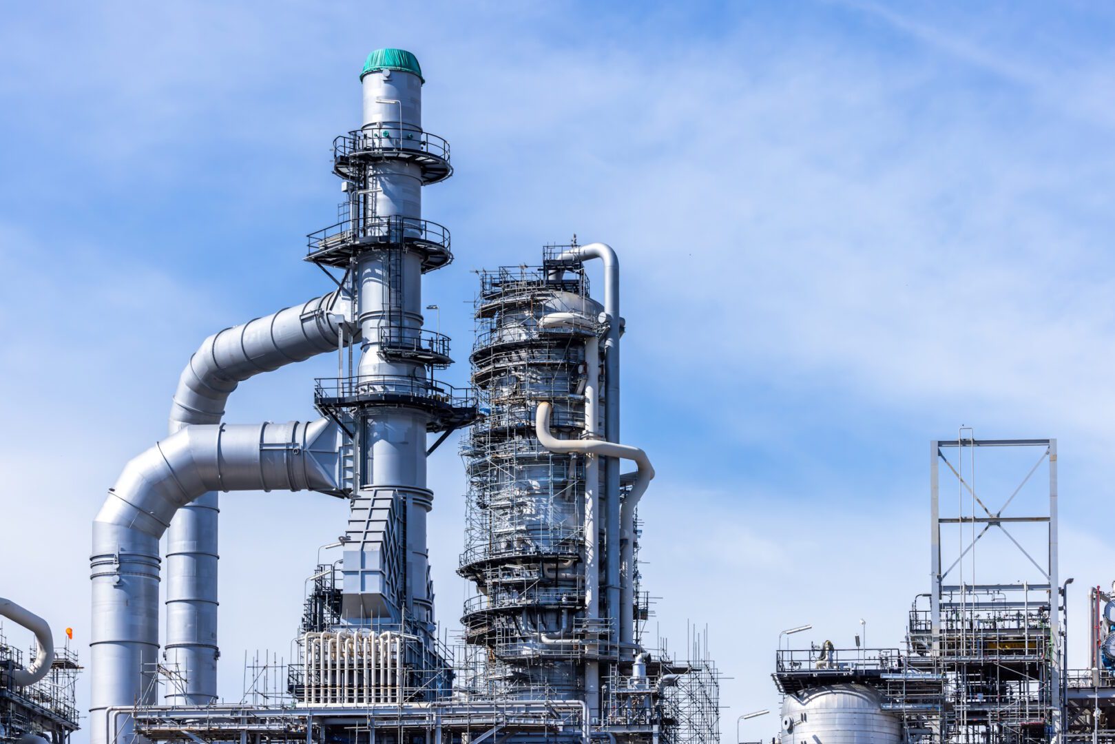 Oil and gas industrial with blue sky background, Oil refinery plant form industry zone, Refinery factory oil storage tank and pipeline steel.